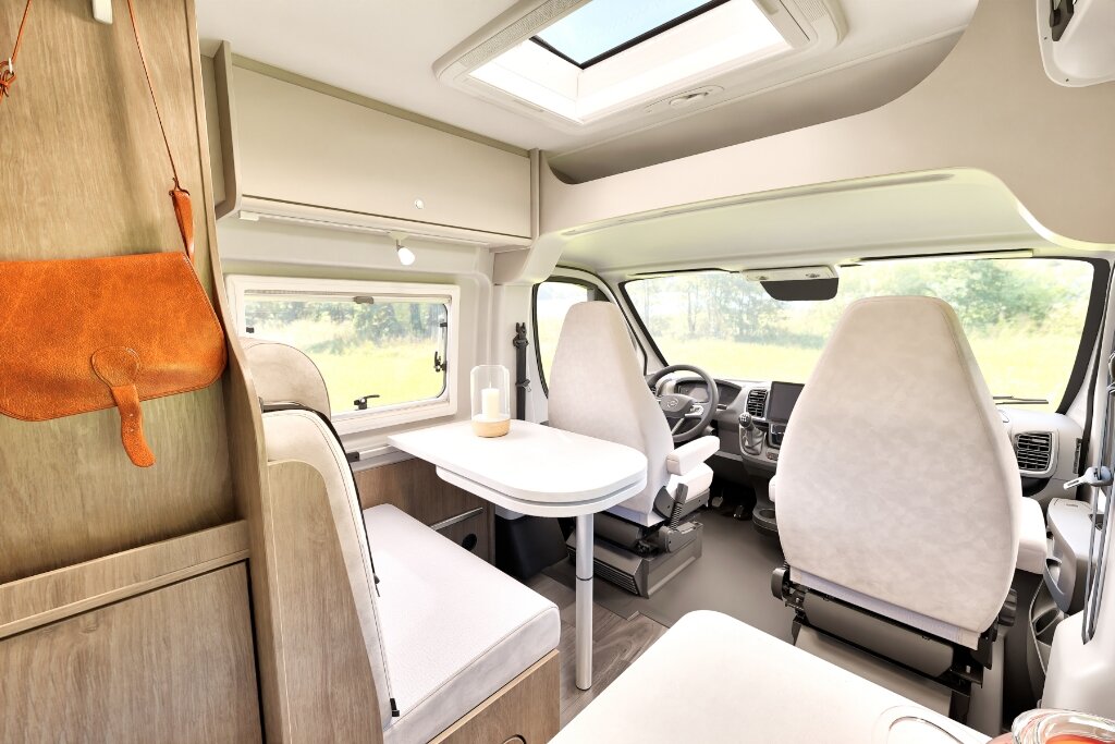 Carado motorhome interior with a seating area, swivelling front seats and a roof window