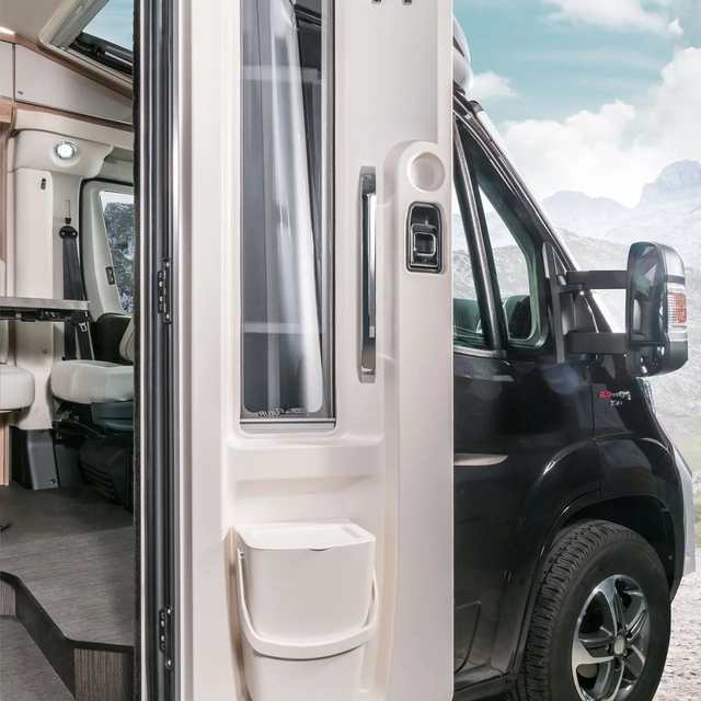 Opened entrance door with integrated rubbish bin in the HYMER Exsis-t motorhome